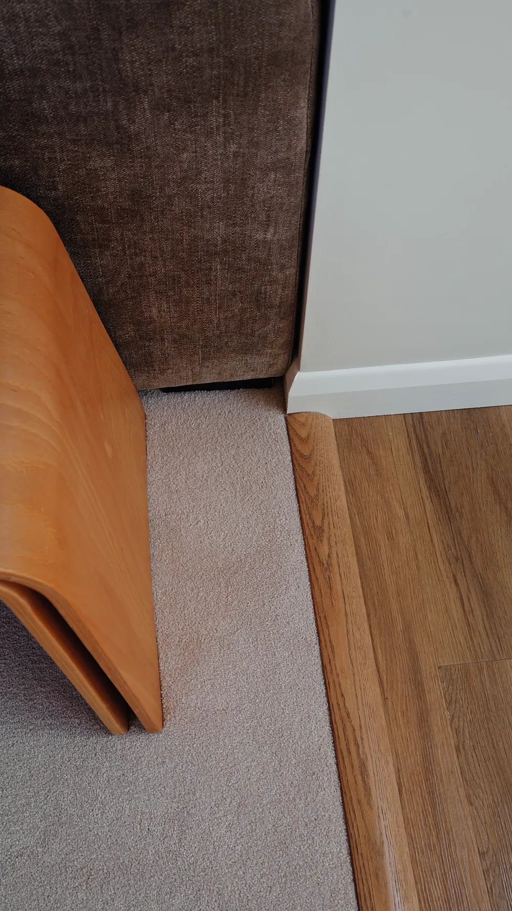A brushed nickel threshold where carpet meets the next room
