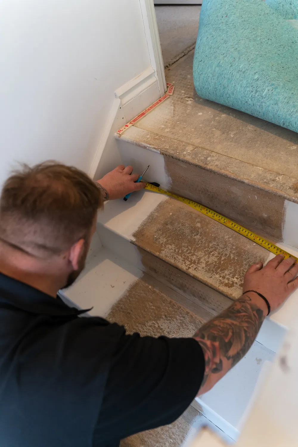 Steve fitting a stair runner in a Brighton home